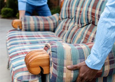 two men move a couch