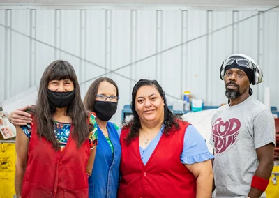 three females and one male employee in the warehouse