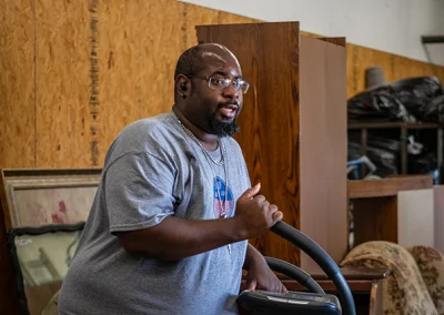 Employee moves donated items with a dolly