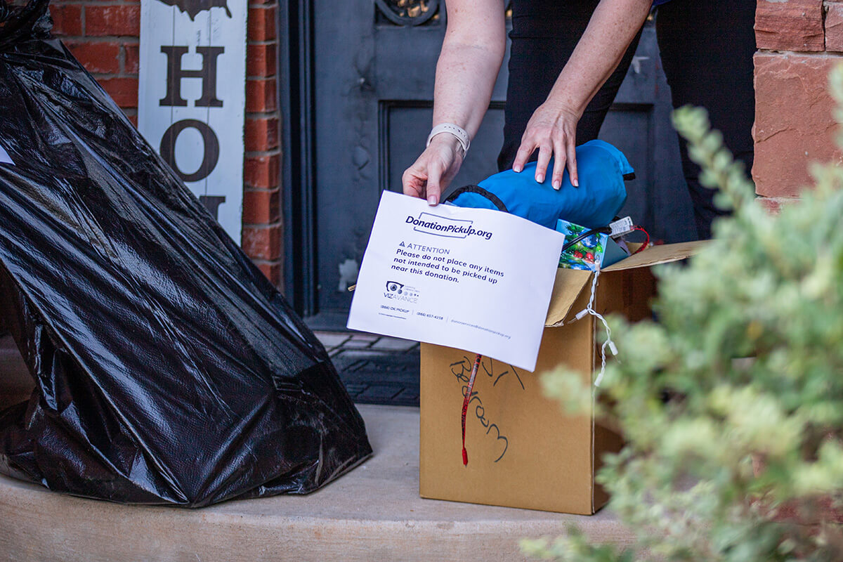 Clear Out Space With a Donation Pick Up Service - Donationpickup A person attaching a label to their donations